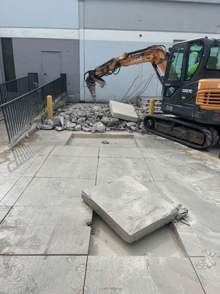 Breaking concrete with an excavator